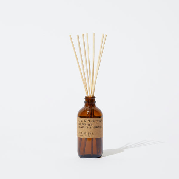 P.F. Candle Co. EU Sweet Grapefruit Reed Diffuser - Product - apothecary-inspired amber glass bottles with our signature kraft label and rattan reeds