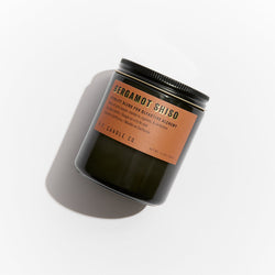 P.F. Candle Co. EU Bergamot Shiso Alchemy Standard Candle - Product - Alchemy Candles feature smoke-colored glass vessels, black metal lids, and gold-leafed labels inspired by vintage window lettering.