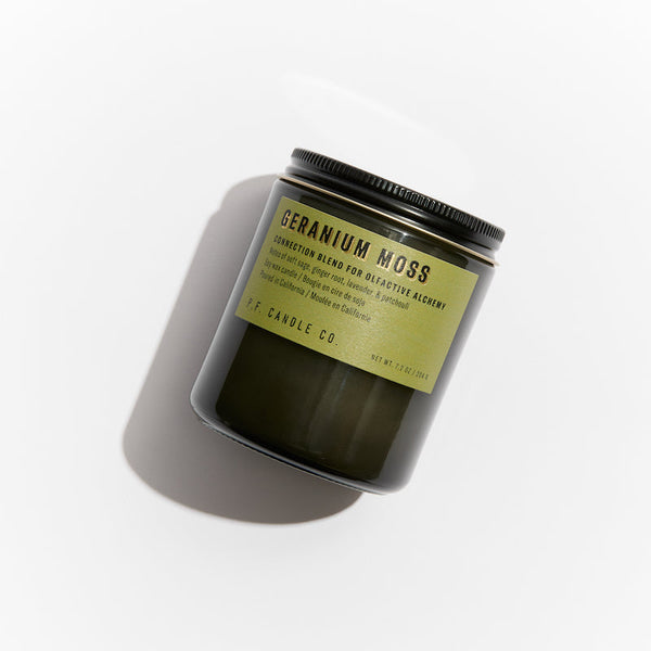 P.F. Candle Co. EU Geranium Moss Alchemy Candle - Product - Alchemy Candles feature smoke-colored glass vessels, black metal lids, and gold-leafed labels inspired by vintage window lettering.