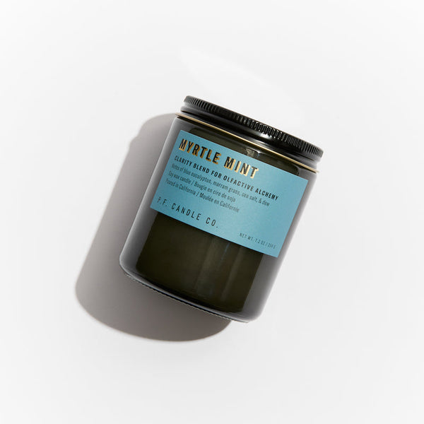 P.F. Candle Co. EU Myrtle Mint Alchemy Candle - Product - Alchemy Candles feature smoke-colored glass vessels, black metal lids, and gold-leafed labels inspired by vintage window lettering.