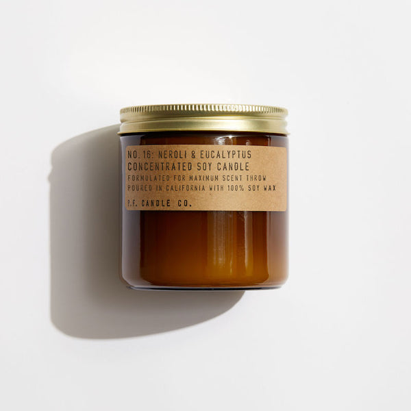 P.F. Candle Co. EU Neroli & Eucalyptus Large Concentrated Candle - Product - Hand-poured into apothecary inspired amber jars with our signature kraft label and a brass lid.