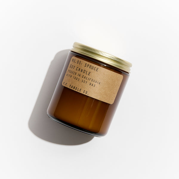 P.F. Candle Co. EU Spruce Standard Candle - Product - Hand-poured into apothecary inspired amber jars with our signature kraft label and a brass lid.