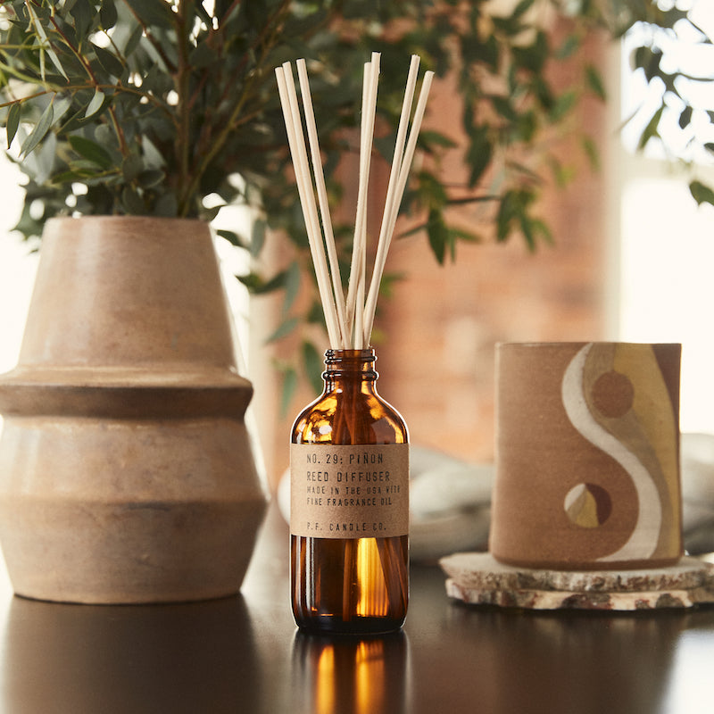 P.F. Candle Co. EU Piñon Reed Diffuser - Lifestyle - Winters in the Southwest, lingering bonfires, wool jackets in rotation. Piñon logs, cedar, and vanilla.