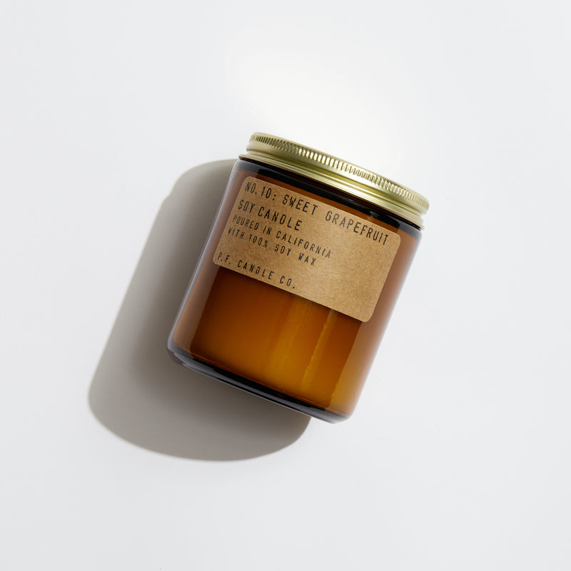 P.F. Candle Co. Sweet Grapefruit Standard Candle - Product - scented soy wax candle hand-poured into apothecary inspired amber jars with our signature kraft label and a brass lid