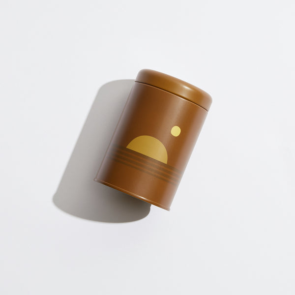 P.F. Candle Co. EU Dusk Sunset Candle - Product - Poured into custom-printed tin vessels donned with earth-toned motifs, sun shapes, and horizon lines inspired by California scenery.