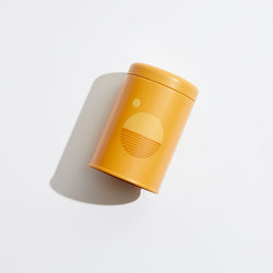 P.F. Candle Co. EU Golden Hour Sunset Candle - Product - Poured into custom-printed tin vessels donned with earth-toned motifs, sun shapes, and horizon lines inspired by California scenery.