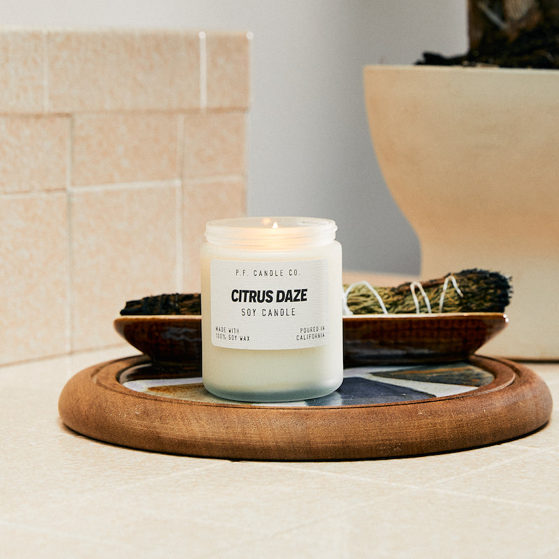 P.F. Candle Co. EU Electric Surf Soft Focus Candle - Lifestyle - Endless citrus groves surrounded by green velveteen hills, lush botanical gardens, discovering fields of wild blooming poppies. Botanical and citrusy. Orange leaf, galbanum, California poppy, and grapefruit.
