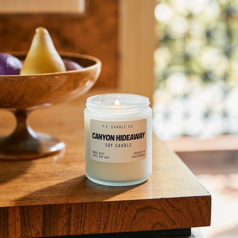 P.F. Candle Co. EU Canyon Hideaway Soft Focus Candle - Lifestyle - Winding drives with the windows down, bohemian cabins tucked amongst California oaks, the aroma of sun-baked earth and chaparral. Woody, smoky, warm, and resinous. Smoked juniper, leather, ginger root, and clove leaf.